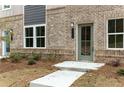 Close-up of the front entrance, showing the brick facade and door with house number at 1162 Buice Lake Pkwy, Acworth, GA 30102