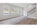 Bright living room with hardwood floors, large windows, and access to outdoor space at 1162 Buice Lake Pkwy, Acworth, GA 30102