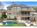 Backyard features a private pool, jacuzzi, and screened porch, ideal for entertaining and relaxing in style at 3520 Millwater Xing, Dacula, GA 30019