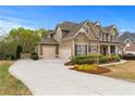 Beautiful home featuring a three-car garage and meticulously maintained landscaping, enhancing curb appeal at 3520 Millwater Xing, Dacula, GA 30019