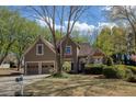 Charming home featuring a well-maintained lawn, a two-car garage, and tasteful landscaping at 2415 Carina Nw Ter, Acworth, GA 30101