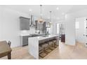Modern kitchen with gray cabinets, stainless steel appliances, a large island, and pendant lighting at 699 Pryor Sw St # 4, Atlanta, GA 30315