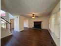 Spacious living room featuring wood floors, fireplace, staircase, and neutral wall paint at 802 Crow View Ct, Woodstock, GA 30189