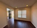 Bright living room with dark wood floors, neutral paint, and natural light from a large window at 802 Crow View Ct, Woodstock, GA 30189