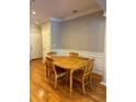 Hardwood flooring, wainscoting, and natural light complement the dining area's inviting ambiance at 1106 Stratford Commons, Decatur, GA 30033