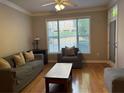 Comfortable living room with hardwood floors, a large window, and neutral decor at 1106 Stratford Commons, Decatur, GA 30033