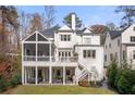 Spacious backyard featuring a covered patio, screened porch, and well-maintained lawn at 803 Courtenay Ne Dr, Atlanta, GA 30306