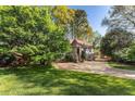 Beautiful home exterior with lush green lawn and large shade trees on a sunny day at 3186 Sugarplum Ne Rd, Atlanta, GA 30345