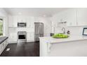 Modern white kitchen with stainless steel appliances, quartz countertops, and cozy window seating at 3186 Sugarplum Ne Rd, Atlanta, GA 30345