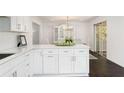 Bright, white kitchen features a breakfast bar with quartz countertops and stainless steel appliances at 3186 Sugarplum Ne Rd, Atlanta, GA 30345