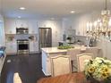 Bright, spacious kitchen featuring white cabinets, stainless steel appliances, and a marble countertop island at 3186 Sugarplum Ne Rd, Atlanta, GA 30345