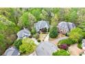 Stunning aerial view of beautiful homes nestled amongst lush green trees in a desirable neighborhood at 460 Laurel Chase Ct, Atlanta, GA 30327