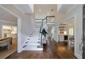 Grand foyer with a soaring staircase, hardwood floors, and views of the dining and living spaces at 460 Laurel Chase Ct, Atlanta, GA 30327