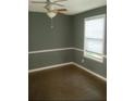 Bedroom with neutral paint, stylish chair rail detail, and a bright window at 5331 Ridge Forest Dr, Stone Mountain, GA 30083