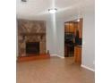 Cozy living room features a stone fireplace, tile floors, and view into the kitchen at 5331 Ridge Forest Dr, Stone Mountain, GA 30083