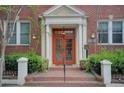 Inviting entryway with classic brick steps leading to a red double door under a decorative white frame at 733 Frederica Ne St # 12, Atlanta, GA 30306