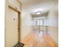 Hallway featuring hardwood floors, neutral walls, and a door with the number 12 at 733 Frederica Ne St # 12, Atlanta, GA 30306