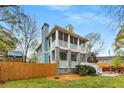 Two-story home with screened porches, stone accents, a tall chimney and fenced yard at 1643 Wade Ne Ave, Atlanta, GA 30317