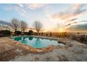 Relaxing pool with a tranquil sunset view, perfect for enjoying the evening at 1909 Hickory Level Rd, Villa Rica, GA 30180