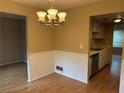 An open dining room shows a decorative chandelier and easy access to the adjacent kitchen area at 2834 Royal Path Ct, Decatur, GA 30030