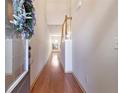 Long hallway with hardwood floors and natural light from the front door and end window at 2930 Smith Ridge Trce, Peachtree Corners, GA 30071