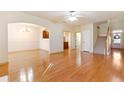 Open living space with hardwood floors, staircase, and open view to dining and kitchen at 2930 Smith Ridge Trce, Peachtree Corners, GA 30071