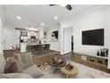 Open-concept living room with a ceiling fan seamlessly connects to the kitchen and dining areas at 901 Abernathy Ne Rd # 3200, Atlanta, GA 30328