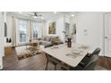 Cozy living room with a ceiling fan, neutral color palette, hardwood floors and a view of the outside through the window at 901 Abernathy Ne Rd # 3200, Atlanta, GA 30328
