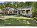 Beautiful brick home featuring a spacious front porch, perfect for relaxing outdoors at 3100 Templeton Ln, Loganville, GA 30052