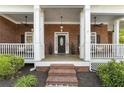 Inviting front porch with brick columns and ample space for seating at 3100 Templeton Ln, Loganville, GA 30052