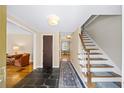 Inviting entryway with slate flooring, wooden staircase, and views into the living spaces at 5016 Chestnut Forest Ct, Dunwoody, GA 30360