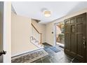 Warm foyer featuring slate floors, an open staircase, and an inviting front door at 5016 Chestnut Forest Ct, Dunwoody, GA 30360