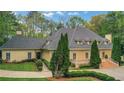 Elegant two-story home surrounded by lush landscaping and mature trees, offering privacy and curb appeal at 3835 Paces Ferry Nw Rd, Atlanta, GA 30327