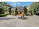Expansive home with mature evergreens, beautiful front yard fountain and long, curved driveway at 3835 Paces Ferry Nw Rd, Atlanta, GA 30327