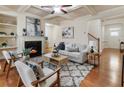 Cozy living room featuring hardwood floors, fireplace, coffered ceilings, and stylish furniture for a welcoming atmosphere at 5016 Whiteoak Se Pointe, Smyrna, GA 30080