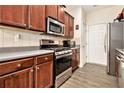 Kitchen features stainless steel appliances, grey counters and warm-toned wood cabinets at 780 Nehemiah Sw Ln # 37, Atlanta, GA 30331