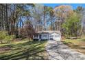 Inviting single-story home with a well-kept lawn, a long driveway, and an attached two-car garage at 90 Chimney Rise Ct, Stockbridge, GA 30281