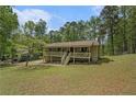 Well-maintained home on a large lot with mature trees and a covered front porch at 10 Powder Dr, Dallas, GA 30157