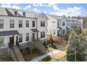 Attractive townhomes featuring black trim, brick bases, and landscaped surroundings at 209 Phillips Ln, Alpharetta, GA 30009