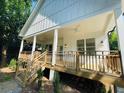 Inviting front porch featuring wood decking, decorative railings, and ample space for seating at 851 Dill Sw Ave, Atlanta, GA 30310