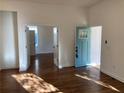 Bright and airy living room with hardwood floors and a view of the front porch and a blue door at 851 Dill Sw Ave, Atlanta, GA 30310