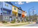A row of colorful townhouses stands proudly on a sunny day, showcasing unique architectural details at 2036 Bixby Byway Se Dr, Atlanta, GA 30317