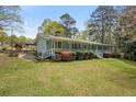 View of a home with covered walkway, brick terrace and garden at 3960 Mason Creek Rd, Winston, GA 30187