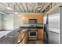 Well-equipped kitchen with stainless steel appliances, black countertops, and stylish lighting at 5200 Peachtree Rd # 3324, Chamblee, GA 30341
