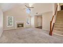 Bright living room with vaulted ceilings, fireplace, and staircase at 10925 Pinehigh Dr, Alpharetta, GA 30022