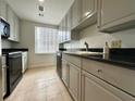 Well lit Kitchen with stainless steel appliances, granite countertop, and tiled flooring at 195 14Th St # 1005, Atlanta, GA 30309