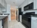 Classic kitchen featuring black appliances and ample storage, with a view into the living space at 195 14Th St # 1005, Atlanta, GA 30309