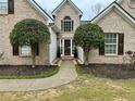 Charming brick home features a well-manicured lawn and mature landscaping for great curb appeal at 2814 Michelle Lee Dr, Dacula, GA 30019