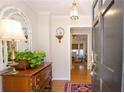Bright foyer with hardwood floors, a decorative mirror, and a charming table with plants that enhance the entryway at 4495 Glengary Ne Dr, Atlanta, GA 30342