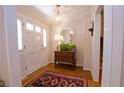 Inviting foyer with hardwood floors, a decorative mirror, and a charming table with plants by the front door at 4495 Glengary Ne Dr, Atlanta, GA 30342